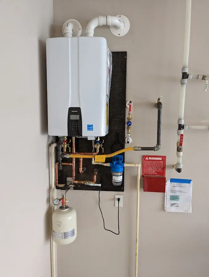 Professional plumber installing copper piping in a King home